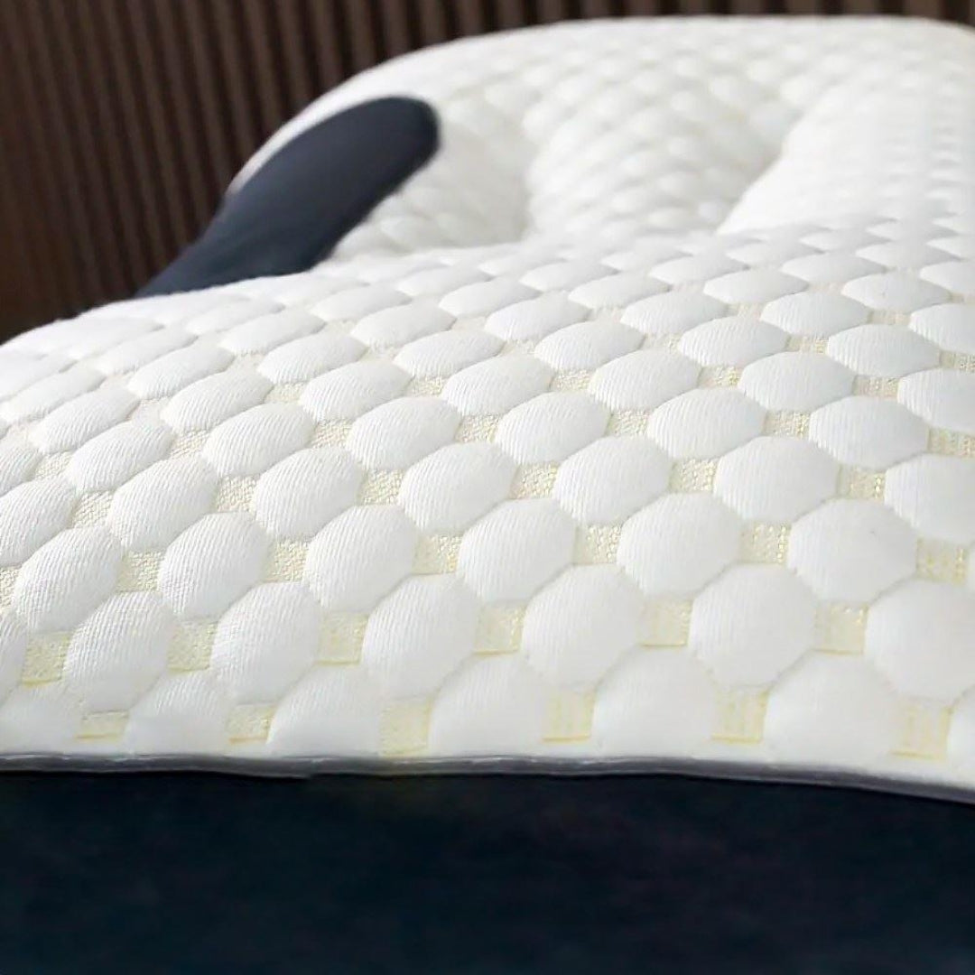 A close up on the breathable material of an ergonomic cervical support pillow for side sleepers.