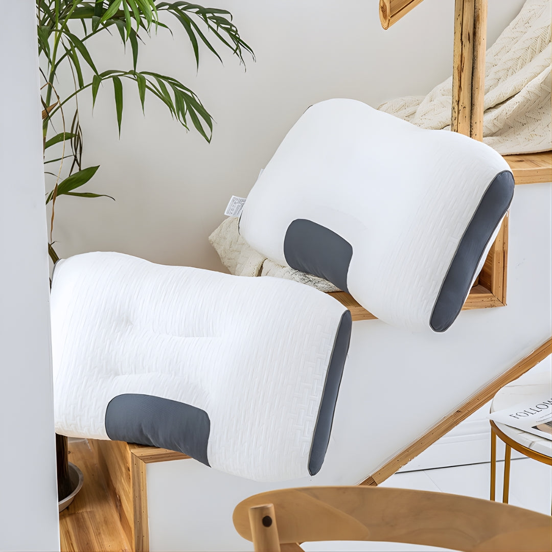 Two ergonomic cervical support pillows for side sleepers shown on top of a staircase.