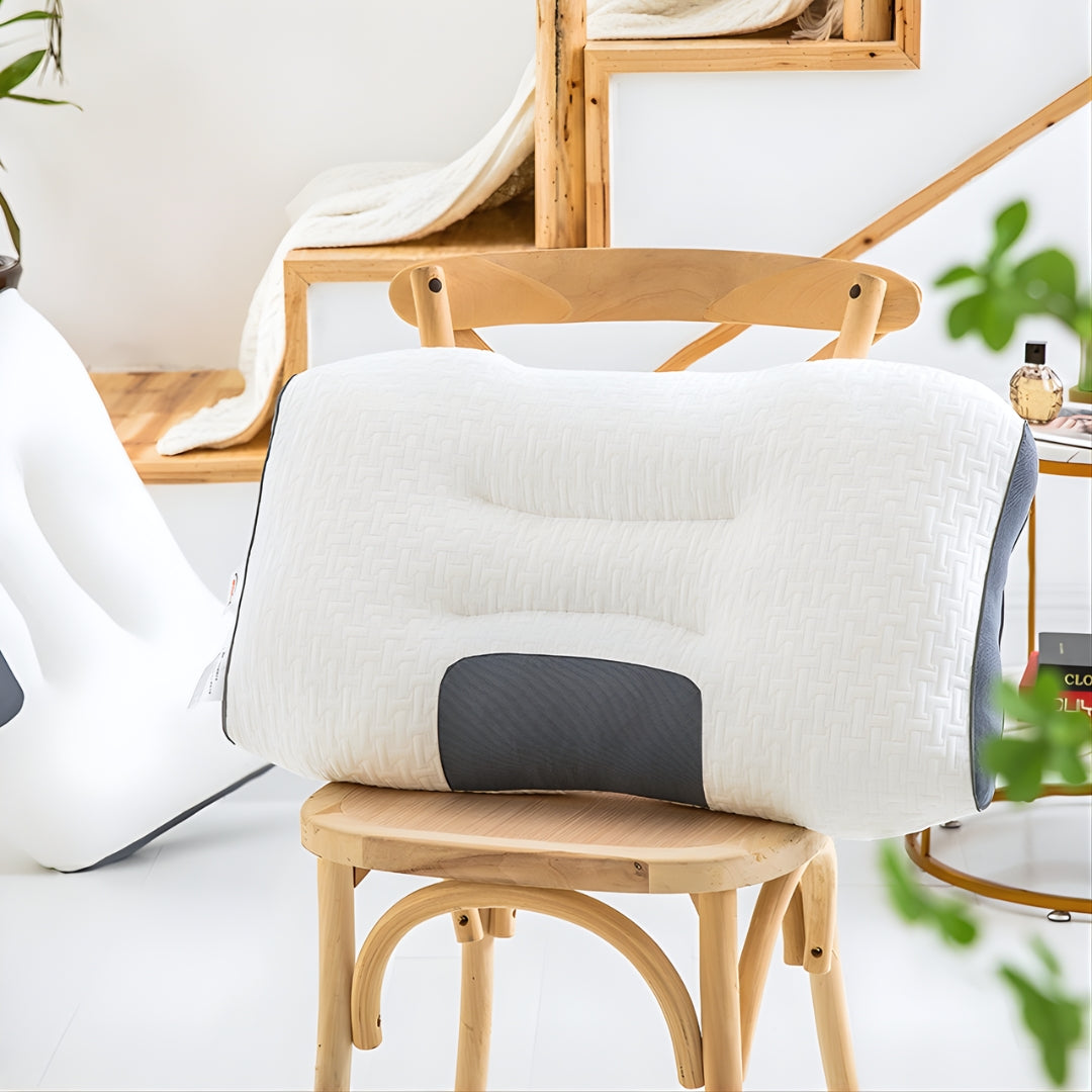 An ergonomic cervical support pillow for side sleepers on top of a chair.