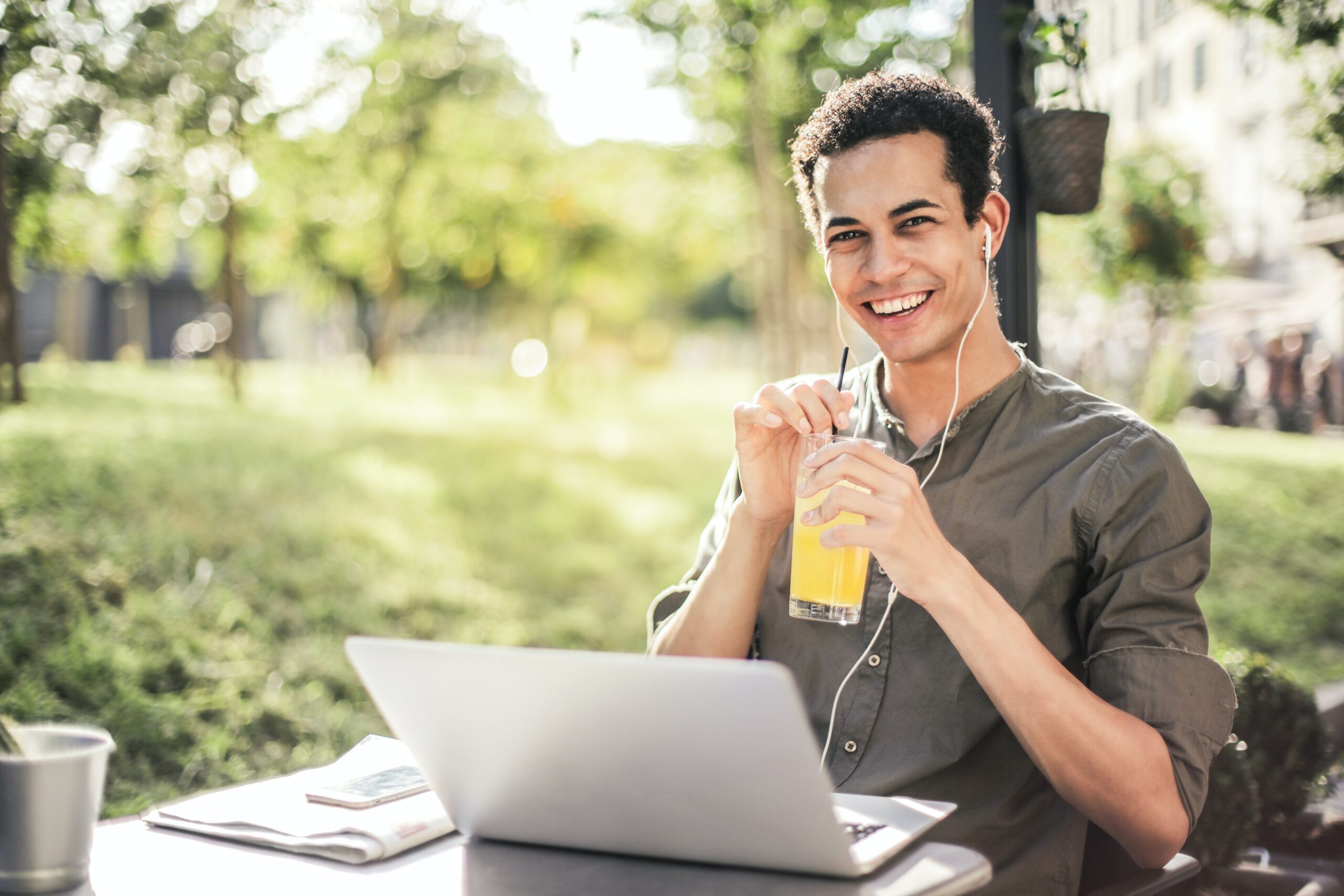 young-man-drinking-juice-in-front-of-laptop