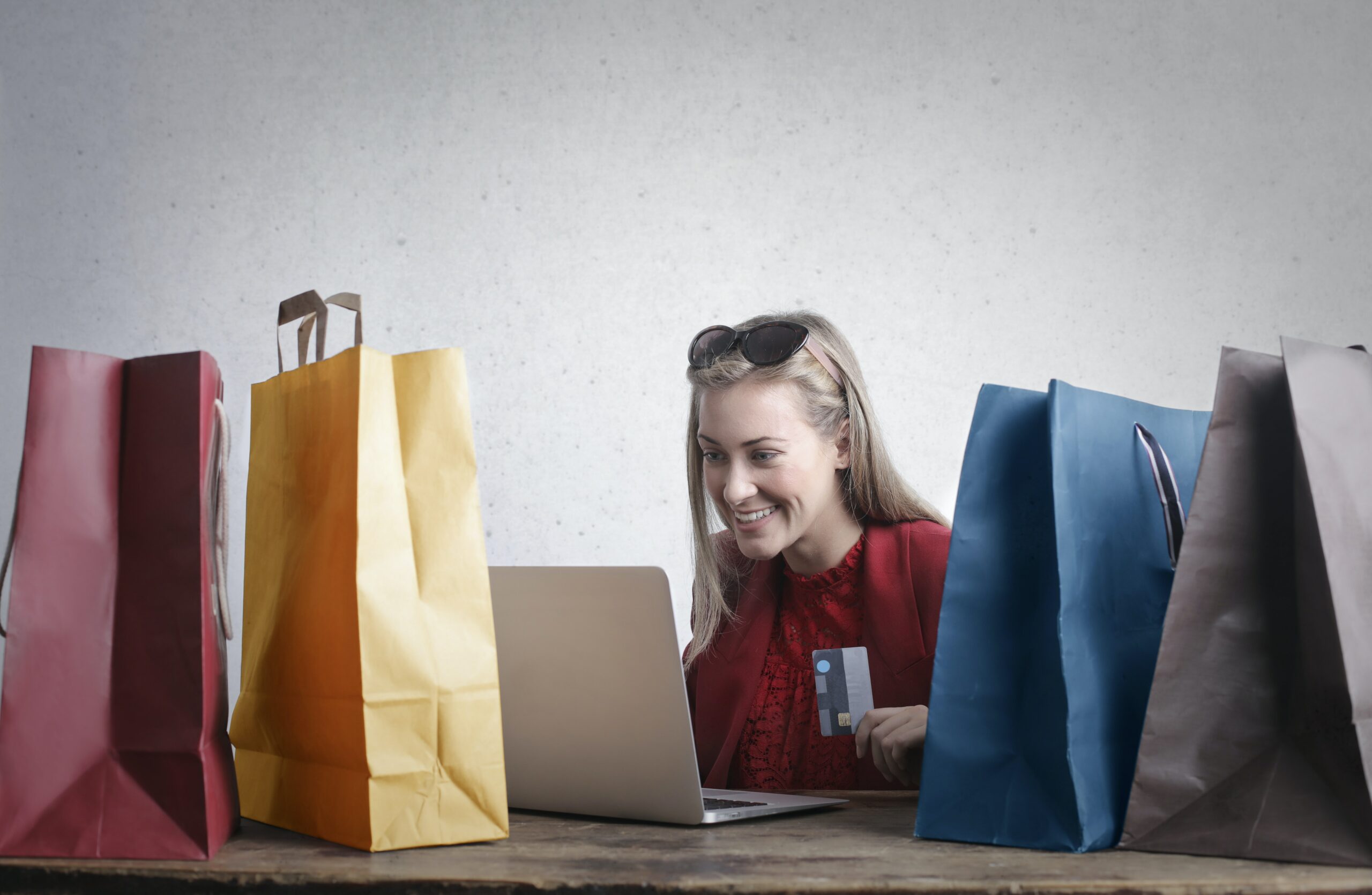 woman-holding-credit-card-in-front-of-shopping-baskets