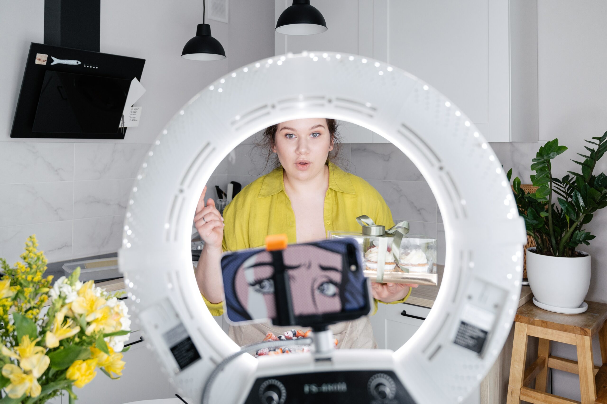 woman-holding-cupcake-filming-with-phone